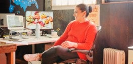 Image of woman wearing red sitting at desk