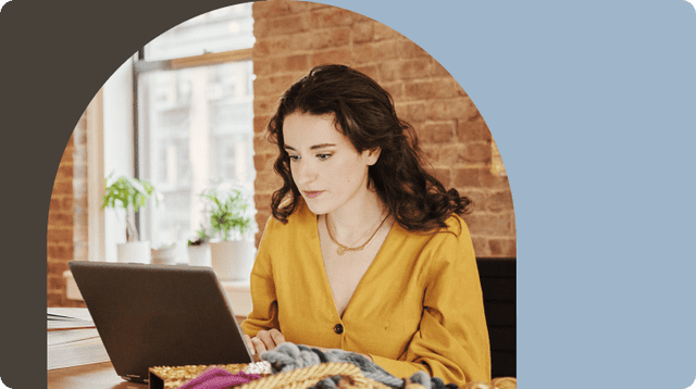 Woman working on laptop in creative space
